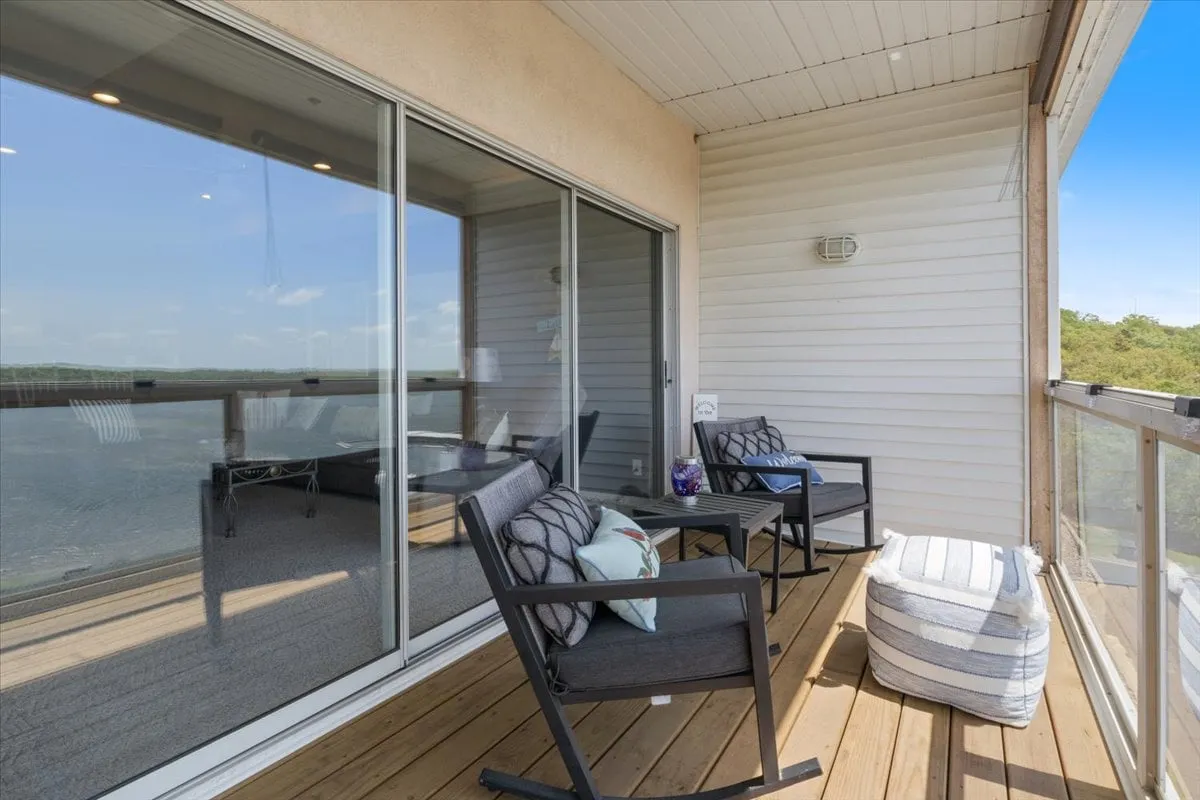 A cozy outdoor seating area with comfortable chairs and decorative pillows, positioned to overlook the water. The image captures the essence of lakeside relaxation after a day of exploration or water sports.