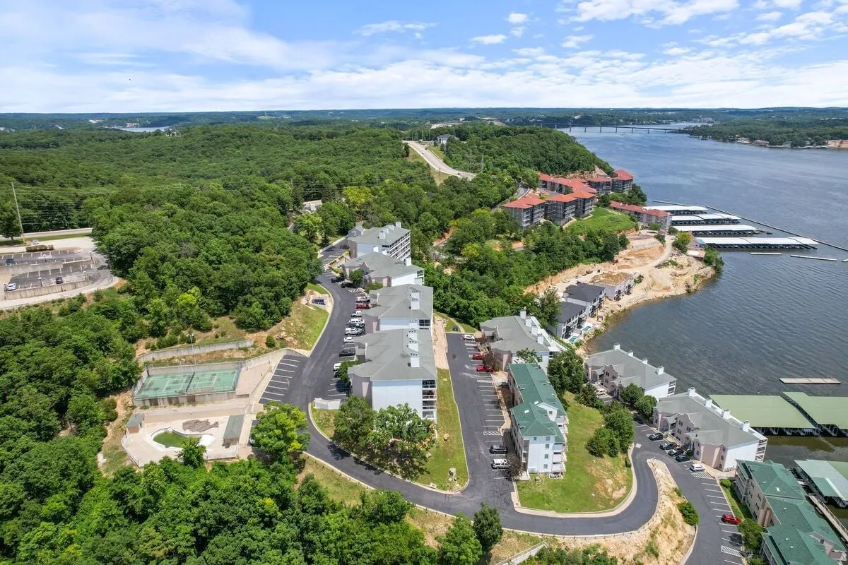 An inviting view of the waterfront and marina, framed by surrounding greenery and accessible roadways. The scene suggests options for boating, nature walks, and community events by the water.